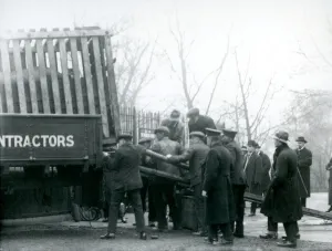 A crowd of onlookers stand by as a Rhinoceros is unloaded from a truck, by keepers A crowd of onlookers stand by as a Rhinoceros is unloaded from a truck, by keepers