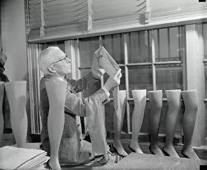Occupations Gallery: David H. Young examining Cotton Stocking, Washington DC, USA, 1941 (b/w photo)