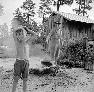 New Deal Gallery: Escambia Farms, Florida. Boiling wash water on the McLelland farm, 1942 (b / w photo)