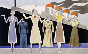 Fashion design showing three female models holding up garments on hangers Fashion design showing three female models holding up garments on hangers