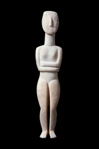 Female idol, schematic figurine - White marble sculpture with ochre incrustations Female idol, schematic figurine - White marble sculpture with ochre incrustations