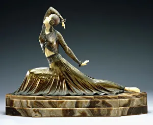 A figure of a dancer, early 20th century (cold-painted bronze and ivory, brown onyx base) A figure of a dancer, early 20th century (cold-painted bronze and ivory, brown onyx base)