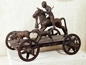 Iron Age: miniature bronze Merida tank representing a wild boar hunting scene Iron Age: miniature bronze Merida tank representing a wild boar hunting scene