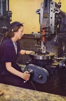 Kathleen McCarthy, formerly a hairdresser, operating a machine for slotting the case striker body of a six-pounder gun