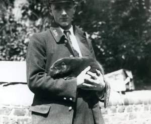 Keeper Leslie Martin Flewin cradles an otter pup in his arms at London Zoo Keeper Leslie Martin Flewin cradles an otter pup in his arms at London Zoo