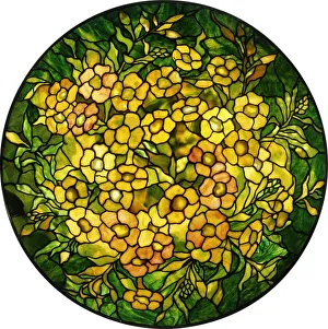 Leaded shade of an Alamander chandelier with amber blossoms and green leaves Leaded shade of an Alamander chandelier with amber blossoms and green leaves
