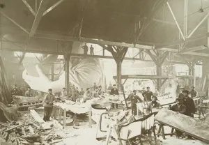 Men in a workshop hammering sheets of copper for the construction of the Statue of Men in a workshop hammering sheets of copper for the construction of the Statue of