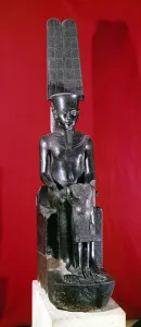 Seated statue of the god Amon protecting Tutankhamun, New Kingdom, c Seated statue of the god Amon protecting Tutankhamun, New Kingdom, c