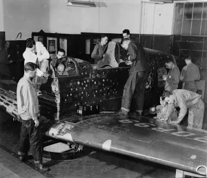 Soldier trainees work on 'Flying Patch,' a Currtiss 'Warhawk" Soldier trainees work on 'Flying Patch,' a Currtiss 'Warhawk"