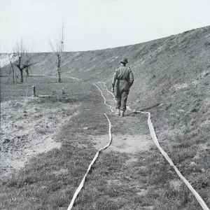 White tape marking clear tracks through a minefield, by the River Senio, Italy White tape marking clear tracks through a minefield, by the River Senio, Italy