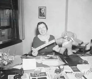 Occupations Gallery: Woman at Office Desk Holding 'Vote Republican' Sign and GOP Elephant, 1936 (b/w photo)