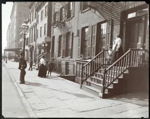 Women and children on and near the stoop of the National Fruit & Flower Guild Women and children on and near the stoop of the National Fruit & Flower Guild