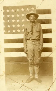 World War I soldier with American flag in background, 1914-18 (b/w photo) World War I soldier with American flag in background, 1914-18 (b/w photo)