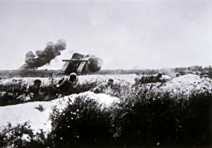 Photographer German Gallery: WWI German stormtroopers armed with flamethrower advance, supported by a captured British Mark IV tank
