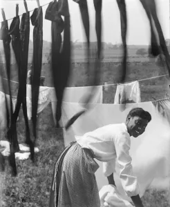 An young African American woman hanging laundry to dry in Newport, Rhode Island, c An young African American woman hanging laundry to dry in Newport, Rhode Island, c