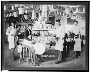 Young Native American men in metalworking workshop with pails, washtubs, watering cans Young Native American men in metalworking workshop with pails, washtubs, watering cans