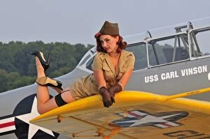 Images Dated 5th August 2009: 1940s style pin-up girl lying on a T-6 Texan training aircraft