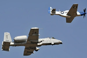 An A-10 Thunderbolt and a P-51 Mustang perform a heritage flight An A-10 Thunderbolt and a P-51 Mustang perform a heritage flight