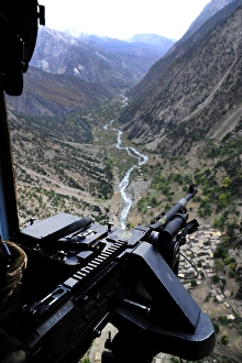 An aerial gunner surveys the surrounding area during a combat mission in Afghanistan An aerial gunner surveys the surrounding area during a combat mission in Afghanistan