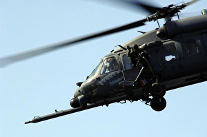 An aerial gunner waves goodbye from an HH-60G Pave Hawk An aerial gunner waves goodbye from an HH-60G Pave Hawk