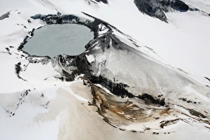 Aerial view of snow-covered Ruapehu volcano summit crater with acidic lake, New Zealand Aerial view of snow-covered Ruapehu volcano summit crater with acidic lake, New Zealand