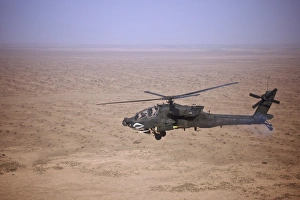 An AH-64D Apache Longbow fires a hydra rocket over Iraq An AH-64D Apache Longbow fires a hydra rocket over Iraq