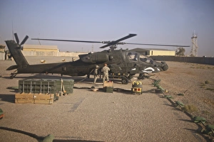 An AH-64D Apache Longbow receives fuel at a military base in Iraq An AH-64D Apache Longbow receives fuel at a military base in Iraq