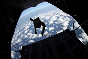Air Force members practice jumping out of an Air Force C-130 Hercules