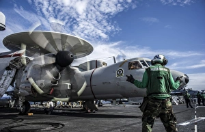 An aircraft director directs an E-2C Hawkeye aboard USS George Washington An aircraft director directs an E-2C Hawkeye aboard USS George Washington
