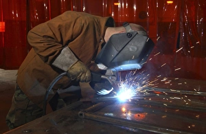 An aircraft metals technician welds framework An aircraft metals technician welds framework