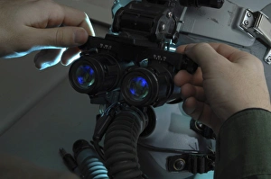 Airman adjusts the eyespan on a pair of night vision goggles Airman adjusts the eyespan on a pair of night vision goggles