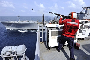 Airman fires a shot line from USS Bonhomme Richard Airman fires a shot line from USS Bonhomme Richard