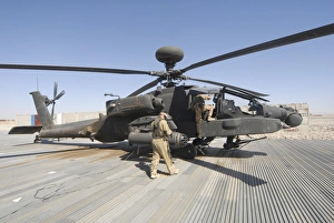 Airmen board an Apache helicopter at Camp Bastion, Afghanistan Airmen board an Apache helicopter at Camp Bastion, Afghanistan