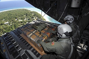 Airmen push out a pallet of donated goods over the Island of Yap from a C-130 Hercules Airmen push out a pallet of donated goods over the Island of Yap from a C-130 Hercules