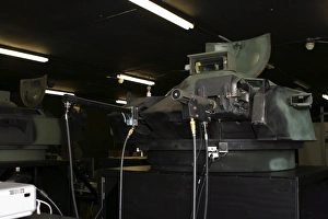 An amphibious assault vehicle turret trainer sits in an old armory building An amphibious assault vehicle turret trainer sits in an old armory building