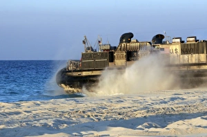 An assault craft heads back to sea after dropping off cargo during an offload An assault craft heads back to sea after dropping off cargo during an offload