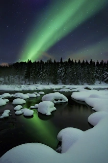 Aurora Borealis over Tennevik River in Troms County, Norway Aurora Borealis over Tennevik River in Troms County, Norway