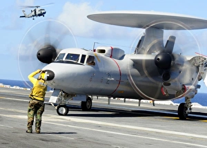 An Aviation Boatswains Mate directs a French E-2C Hawkeye abord USS Theodore Roosevelt An Aviation Boatswains Mate directs a French E-2C Hawkeye abord USS Theodore Roosevelt