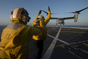 Aviation Boatswains Mates direct an MV-22 Osprey on the flight deck Aviation Boatswains Mates direct an MV-22 Osprey on the flight deck