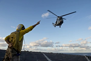 Boatswainas Mate signals to a French Armee De Terre SA 380 Puma helicopter Boatswainas Mate signals to a French Armee De Terre SA 380 Puma helicopter