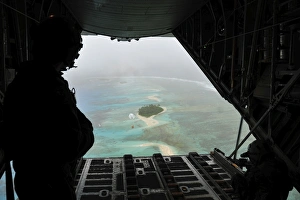 A bundle of donated goods drifts to an island after being dropped out the back of A bundle of donated goods drifts to an island after being dropped out the back of