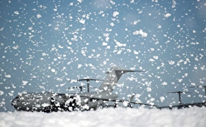 A C-17 Globemaster III on the flight line as fire retardant foam is released A C-17 Globemaster III on the flight line as fire retardant foam is released