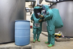 CBRN defense specialists check a barrel for contamination CBRN defense specialists check a barrel for contamination