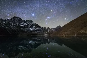 Mountain Range Gallery: Celestial sky with Sirius, Orion and Aldebaran shining bove Pharilapche Peak in Nepal