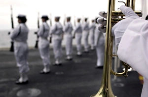 Ceremonial Honor Guard members stand at port arms during a burial at sea ceremony Ceremonial Honor Guard members stand at port arms during a burial at sea ceremony
