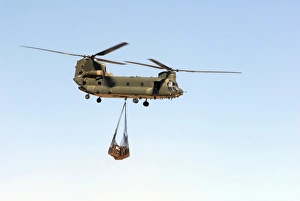 A CH-47 Chinook of the Royal Air Force transports a sling load of pallets A CH-47 Chinook of the Royal Air Force transports a sling load of pallets