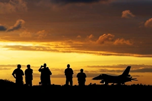 A Chilean Air Force F-16 aircraft landing at sunset A Chilean Air Force F-16 aircraft landing at sunset