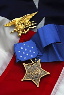 Close-up of the Medal of Honor award and American flag Close-up of the Medal of Honor award and American flag