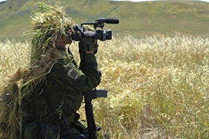 A combat videographer practices evasion techniques A combat videographer practices evasion techniques