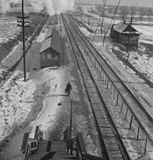 Conductor walks to the passenger station to wait for a suburban train to go home, 1943 Conductor walks to the passenger station to wait for a suburban train to go home, 1943